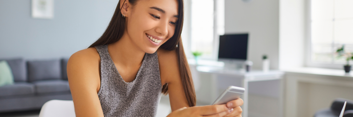 girl smiling at phone